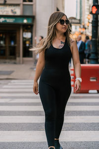 Full length of young woman standing in city