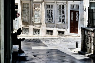 Woman sitting on doorstep