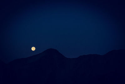 Low angle view of moon in sky at night