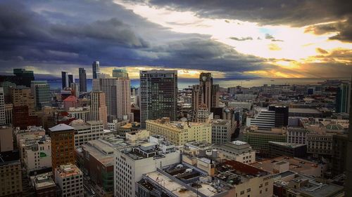View of cityscape against cloudy sky
