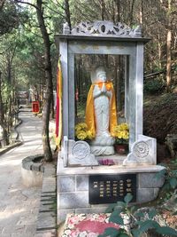 Statue against trees