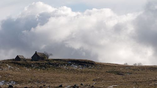 Panoramic view of rocks on land against sky