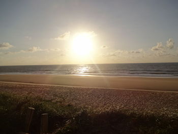 Scenic view of beach against sky during sunset