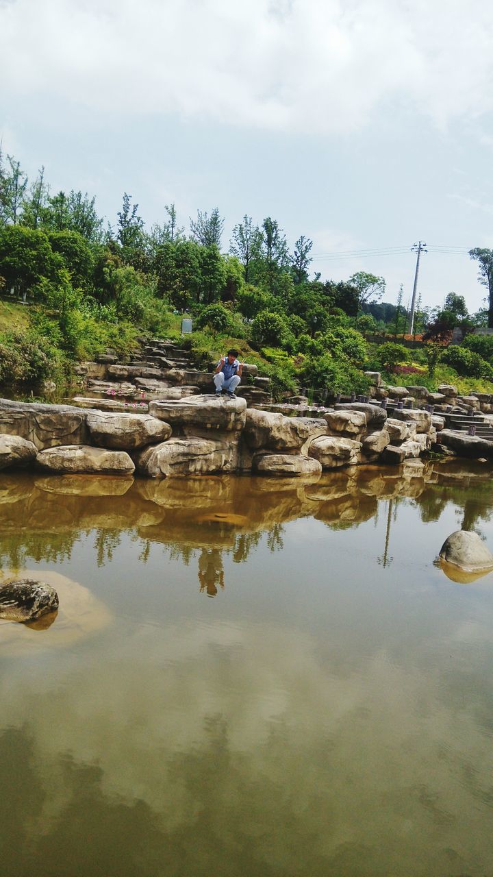 water, sky, reflection, cloud - sky, tranquility, waterfront, lake, nature, tranquil scene, tree, rock - object, cloudy, scenics, pond, cloud, beauty in nature, day, standing water, outdoors, stone - object