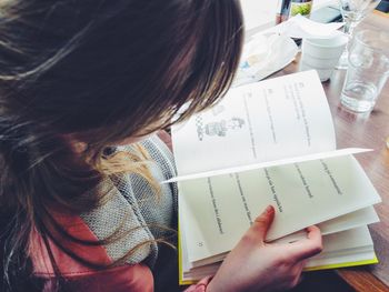 Cropped image of woman holding book