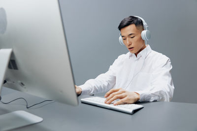 Young woman using laptop at table