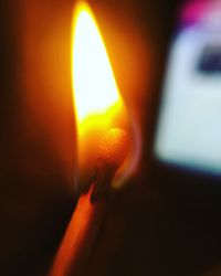 Close-up of illuminated lamp at sunset