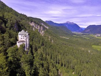 Scenic view of trees and mountains against sky