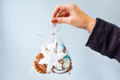 Close-up of hand over white background