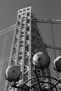 Low angle view of communications tower against sky in city