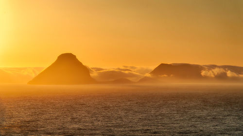 Scenic view of mountains against sky during sunset