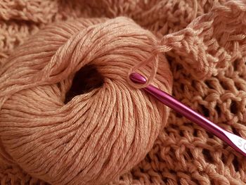 High angle view of wool with knitting needle