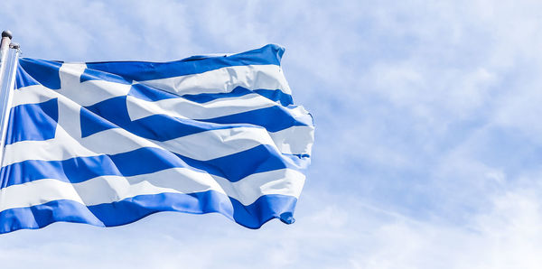 Low angle view of flag against sky