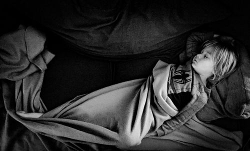 High angle view of boy sleeping on bed at home