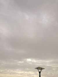 Low angle view of windmill against sky