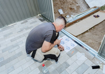 High angle view of man exercising on footpath