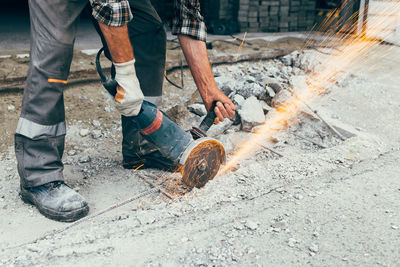 Low section of man working on fire