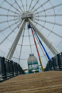 Low angle view of ferris wheel against sky