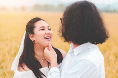 Happy lesbian couple standing on land