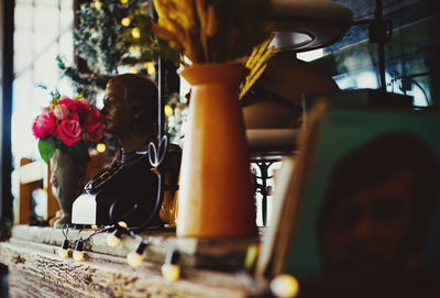 Close-up of flower vase on table at home