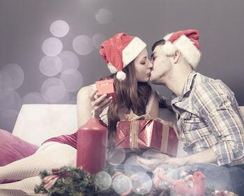 Close-up of young couple on christmas tree