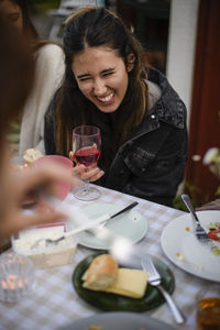 Portrait of smiling friends having food at restaurant