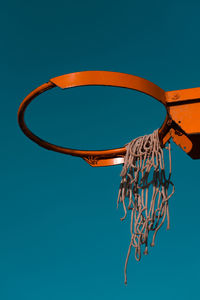 Low angle view of basketball hoop against blue sky