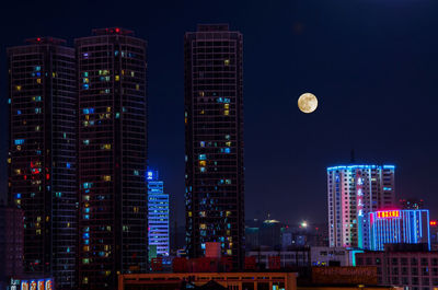 Low angle view of skyscrapers lit up at night