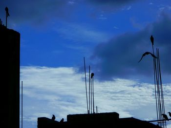 Low angle view of street light against cloudy sky
