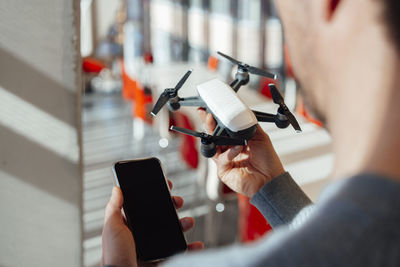 Businessman with mobile phone and drone at office