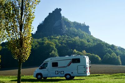 Scenic view of mountains with camper 