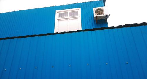 Low angle view of building against clear blue sky