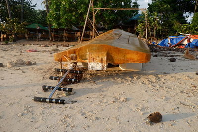 Abandoned cart on sand at beach