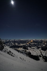 Aerial view of snow covered landscape against clear sky at night