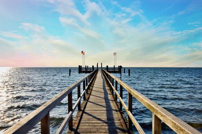 Pier over sea against sky