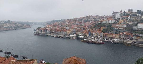 High angle view of buildings by sea against sky