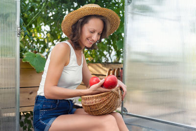 Portrait of young woman sitting at home