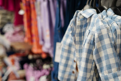 Close-up of clothes hanging for sale