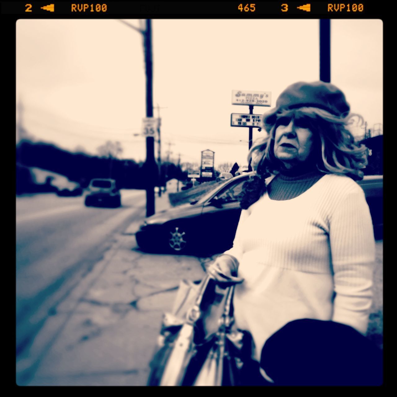 CLOSE-UP OF YOUNG WOMAN ON CAR