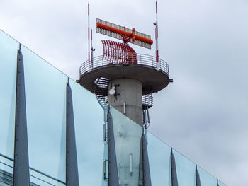 Low angle view of crane against sky