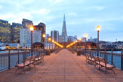 View of illuminated city buildings against sky