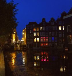 Illuminated buildings against blue sky