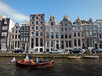 Boats in canal with buildings in background