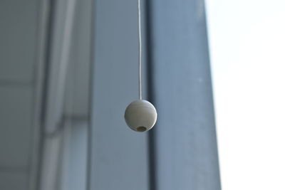 Low angle view of electric lamp hanging on ceiling