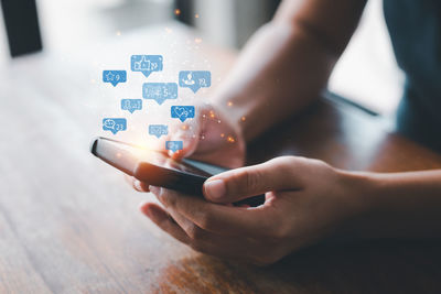 Midsection of person using mobile phone