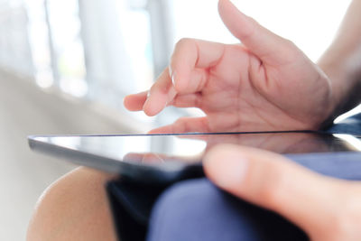 Cropped image of person using digital tablet