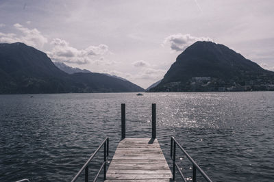 Pier over lake against sky