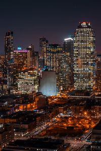 Illuminated cityscape against sky at night