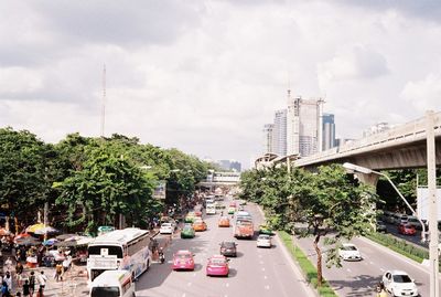 View of vehicles on road along buildings