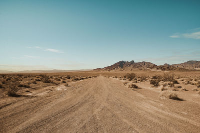 Dirt road amidst land